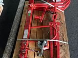 a red machine that is sitting on top of a pallet