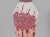 a vase that has a pink and white design on it