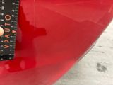 a sticker on the hood of a red car that has a sticker on it