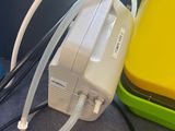 a yellow box with a white hose attached to it and a yellow box with a white hose attached to it and a yellow box with a white hose attached
