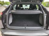 the back of a car with its trunk open in a parking lot