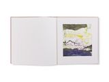 an open book with a picture of a landscape on it