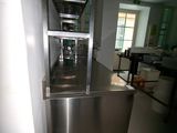 a stainless steel counter in the middle of a kitchen