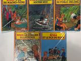 quatre livres pour enfants sont alignés sur une surface blanche