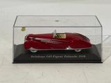 an old model of a red car in a clear display case