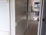 a white refrigerator sitting in the middle of a room