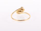 a close up of a gold ring on a white surface