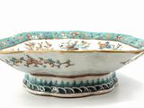 a white bowl with a blue and green design on it