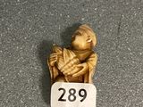 a small figurine of a monkey sitting on a chair