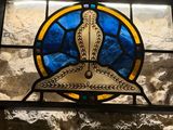 a stained glass window with a picture of a bird on it