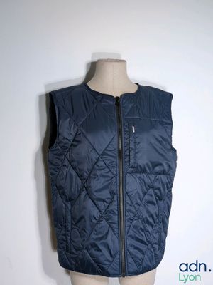the vest is blue and has a zipper on the front