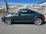 an image of a grey sports car parked in a parking lot