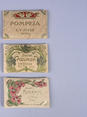 four different types of perfume labels on a white surface