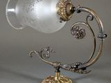 a glass lamp that is sitting on a table