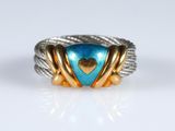 a close up of a ring with a heart on it