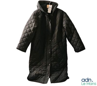 une photo d'un manteau noir suspendu à un cintre