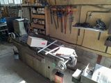an image of a workbench in a workshop with tools on the wall