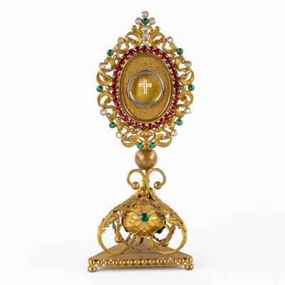 a close up of a gold and green clock on a stand