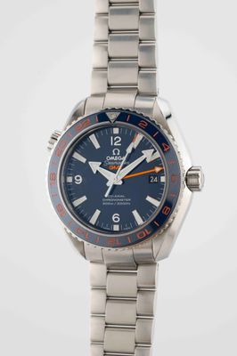 a close up of a wrist watch with a blue dial