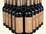 six bottles of red wine are lined up in a row