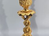 an image of a gold colored candle holder with a snake on it