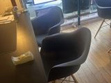 a room with a desk, chairs, and a television in it