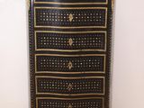 a black and gold chest of drawers with a marble top
