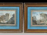 deux tableaux encadrés représentant un bâtiment et un autre bâtiment sur fond bleu