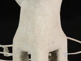 a white stone lamp that is sitting on a table