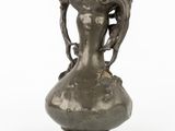 a silver vase with a handle on a white background