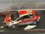a small red car in a display case on a table