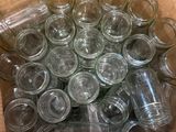 a box full of empty glass jars sitting on a table