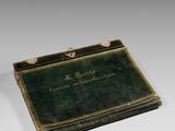 an old book sitting on top of a white table