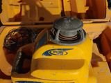 a yellow toy boat sitting on top of a pile of other toys