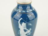 a blue vase with a picture of a man on it