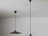 two lights hanging from the ceiling in a room