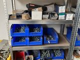 many different types of screws and nuts on the shelves