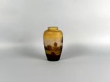 a small yellow vase with a landscape on it