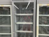two refrigerators that are open in a store
