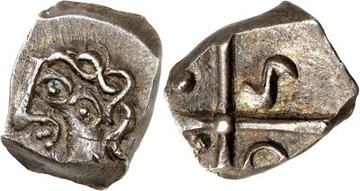 a close up of a silver coin with a design on it