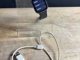an apple watch is connected to a charger on a wooden table