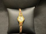an image of a watch sitting on top of a pillow on a pillow