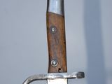 a close up of a knife with a wooden handle