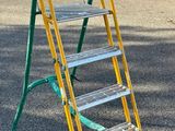 a yellow ladder that is sitting on the ground