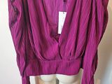 a close up of a purple top on a mannequin mannequin
