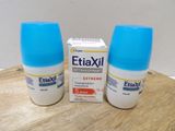 two bottles of eliaxil sitting on a table next to a box of pills