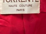 a label on a red dress that says torrente haute couture paris