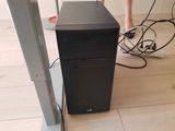 a black computer tower sitting on a hard wood floor