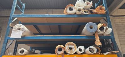 many rolls of toilet paper sitting on a shelf
