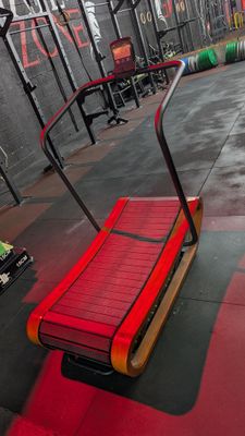a red bench in the middle of a gym